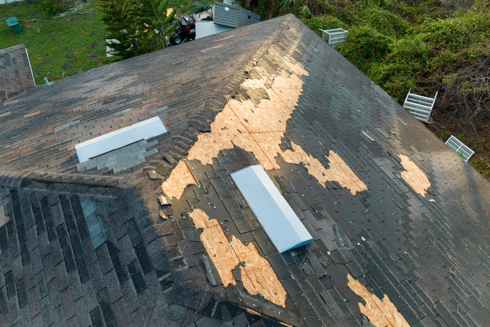 Roof tiles with surface damage before roof cleaning and repairing service in Derby
