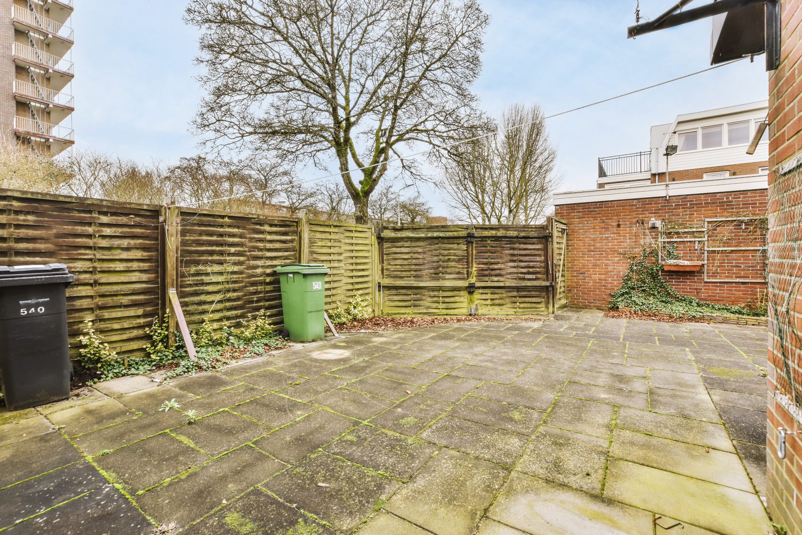 Dirty patio surface with moss and grime buildup in Derby garden before pressure washing
